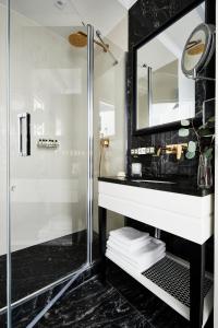 a bathroom with a shower and a sink and a mirror at Hotel Teatro Boutique Old Town in Warsaw