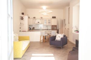 a living room and kitchen with a couch and chairs at Casa Julia in Menaggio