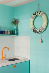 a kitchen with a sink and a lifesaver hanging from the wall at The Courtyard Suite by Margate Suites in Margate