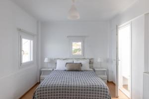 Postel nebo postele na pokoji v ubytování Sea Wind Apartments