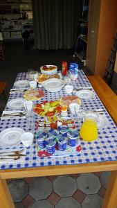 a table with plates of food on a table at Blue Lake Luxury Rooms in Grabovica