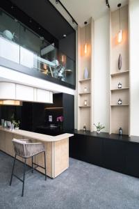 a kitchen with a large counter and a chair at Hotel NuVe Elements in Singapore