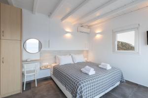 Postel nebo postele na pokoji v ubytování Sea Wind Apartments
