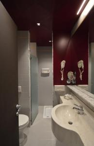 a bathroom with a sink and a toilet at Hotel Friuli in Udine