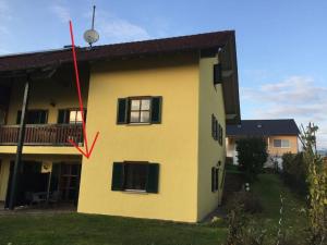 a yellow house with a red arrow on the side of it at Komfort Feriendomizil JAKOBI in Dietfurt