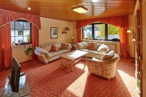 a living room with two couches and a tv at Gasthaus Mester in Oedingen