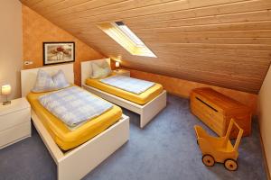 a bedroom with two beds and a wooden ceiling at Gasthaus Mester in Oedingen