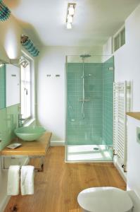 a bathroom with a glass shower and a sink at Meerhaus Niendorf in Niendorf