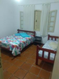 Postel nebo postele na pokoji v ubytování Casa de Praia em Figueira Arraial do Cabo