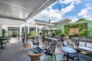 an outdoor patio with tables and chairs at Mercure La Roche Sur Yon in La Roche-sur-Yon