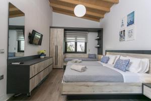 a bedroom with a large bed and a mirror at Villa Stavelia in Gouves +22 photos