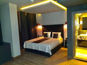 a bedroom with a bed and a large mirror at International Palace in Veles +80 photos