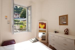 A bed or beds in a room at Casa Julia - Menaggio by LoveComo