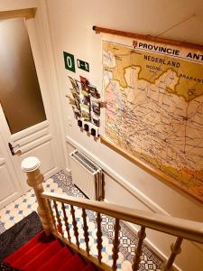 a large map hanging on a wall next to a staircase at B&B Toast Hoogstraten in Hoogstraten