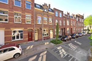 a city street with cars parked in front of brick buildings at Bed & Coffee Inn d'n Acht in Venlo