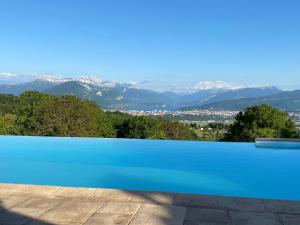 a swimming pool with a view of mountains at Chalet le Pré de la Dame in Épagny