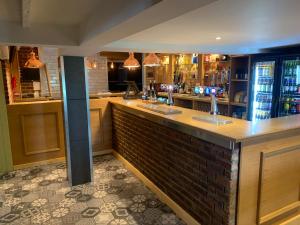 a bar in a restaurant with a brick counter at The White Horse in Cranswick