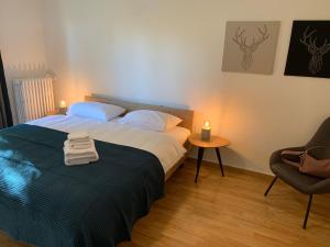 a bedroom with a bed with two towels on it at Modern 2 bedroom apartment close to Zurich airport in Opfikon