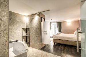 a bathroom with a bed and a shower with a mirror at FOURHEADS Private Suites in Rome