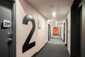 a hallway with a number on the wall at B&B HOTEL Ouistreham in Ouistreham