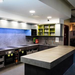 a large kitchen with a large island in the middle at Kinlay Hostel Eyre Square - Best Hostel in Ireland 2025 in Galway +38 photos