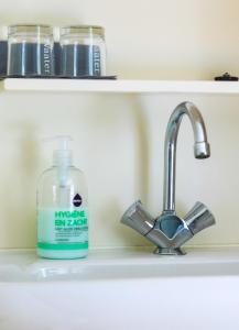 a bathroom sink with a bottle of hygeine expert soap at Hotel Restaurant In d'Ouwe Peel in Helenaveen