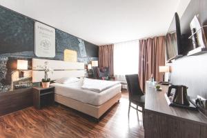 Postel nebo postele na pokoji v ubytování PLAZA Hotel Hanau