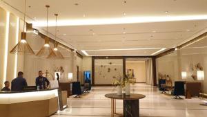 a lobby of a hotel with people standing in the lobby at Luxe Gold Mactan in Mactan +33 photos