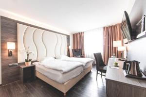 Postel nebo postele na pokoji v ubytování PLAZA Hotel Hanau