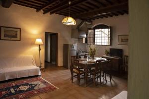 a kitchen and living room with a table and a bed at Agriturismo Quercesecca - Nature & Relax in Marina di Grosseto
