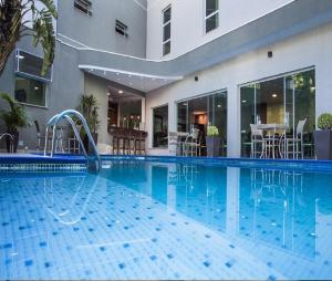 a swimming pool with a slide in a building at Hotel Serra de Jundiaí in Jundiaí
