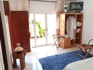 a bedroom with a door and a room with a bed at Sparkle Guest House - Self-Catering, Pool, Garden in Maputo