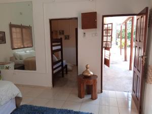 a room with a bedroom with a bed and a mirror at Sparkle Guest House - Self-Catering, Pool, Garden in Maputo