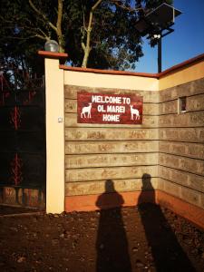 a shadow of a person standing in front of a wall at Ol marei Home in Nanyuki
