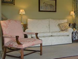 a living room with a couch and a chair at Manor Farm Egerton in Malpas