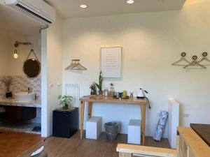 a kitchen with a table and a counter in a room at W24墾丁民宿墾丁大街一館bnb in Kenting