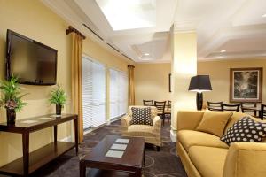 a living room with a couch and a tv at Holiday Inn Express Pembroke by IHG in Pembroke