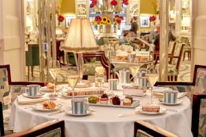 a table with plates of food and glasses of wine at Claridge's in London