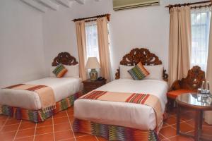 Postel nebo postele na pokoji v ubytování Hotel Spa Posada Tlaltenango