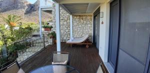 a balcony of a house with a bath tub on it at Artemis Village Apartments & Studios in Stavros