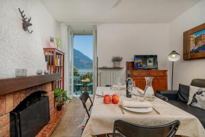 a living room with a table and a fireplace at Casa Bella in Varenna