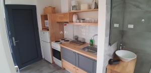 a small kitchen with a sink and a stove at Artemis Village Apartments & Studios in Stavros