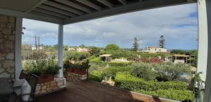 a balcony with a view of a garden at Artemis Village Apartments & Studios in Stavros