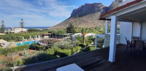 a balcony of a house with a view of a mountain at Artemis Village Apartments & Studios in Stavros