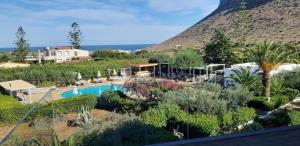 a resort with a swimming pool and a mountain at Artemis Village Apartments & Studios in Stavros