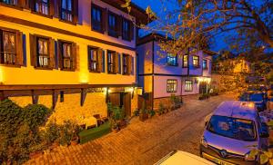 a street in an old town at night at Gunes Konak Otel Safranbolu in Safranbolu