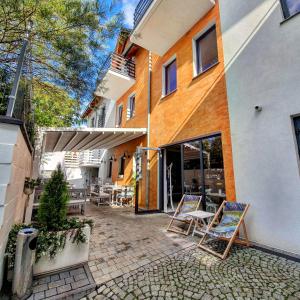 a patio with chairs and tables in front of a building at Laura Spa in Łagów