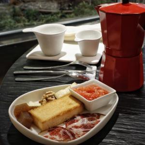 a plate of food on a table with a plate of food at Zenit Convento San Martin in Donostia-San Sebastián