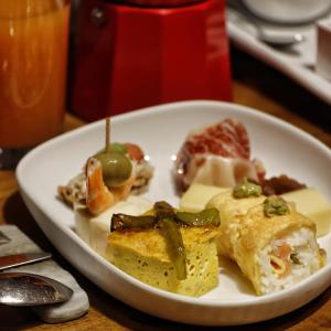 a white plate of food on a table at Zenit Convento San Martin in Donostia-San Sebastián