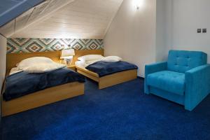 Posteľ alebo postele v izbe v ubytovaní Hotel Zalesie